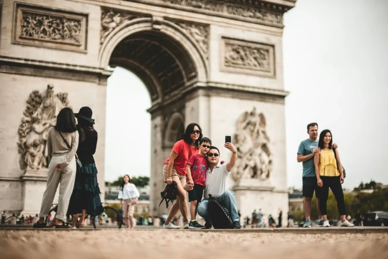 A group of young travelers at the Arc de Triomphe in Paris
