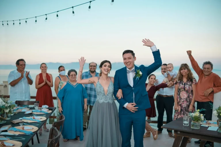 Wedding couple celebrating with guests on the beach