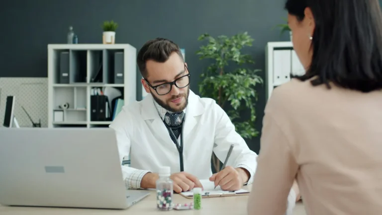 Doctor taking notes during a consultation with a patient