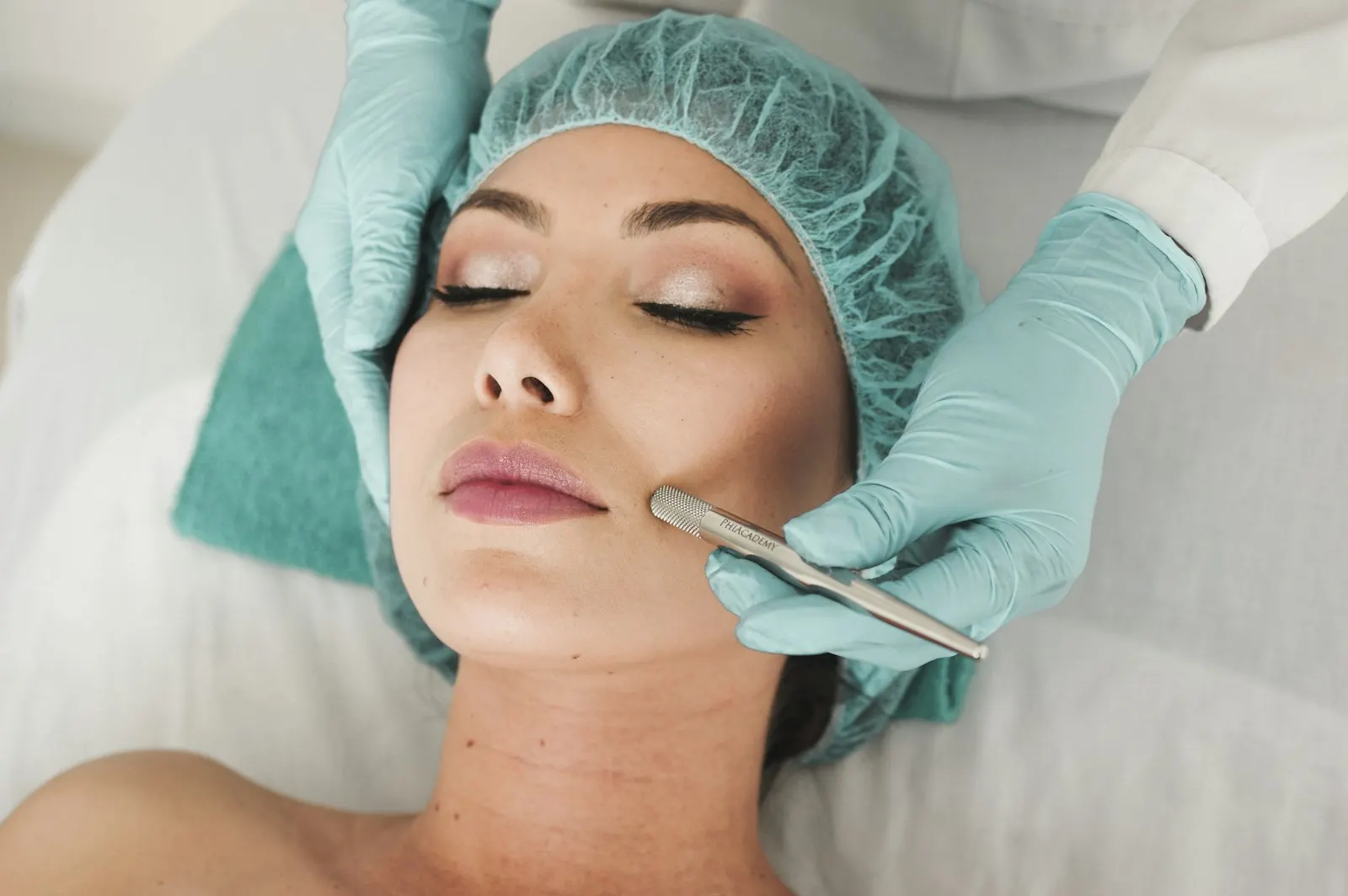 Patient in a surgical cap during a cosmetic consultation